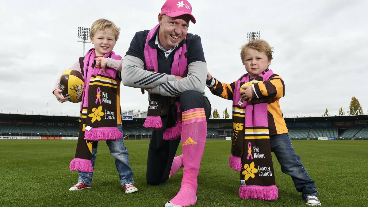 Hawthorn’s Tasmanian operations manager David Cox with young Hawks supporters Hamish, 4, and Rupert Williams, 2.  Picture: MARK JESSER
