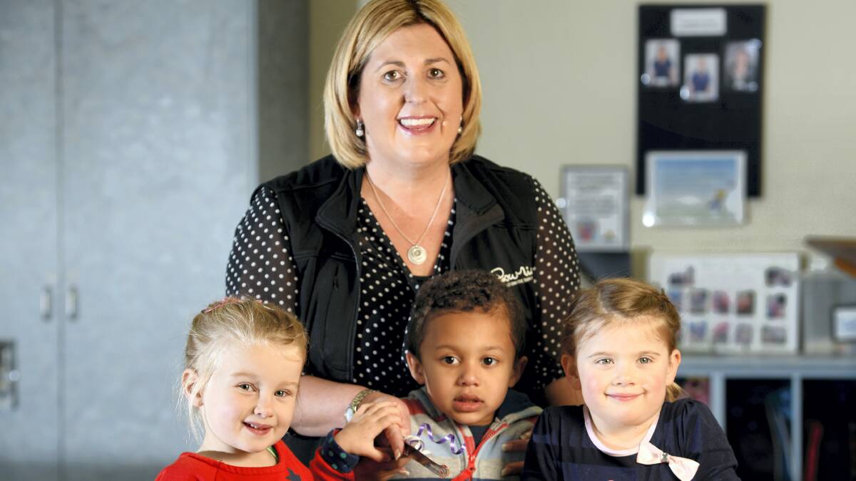 Stella Hogarth, 4, Malakai Diallo, 4, and Georgina Hart, 3, with Lady Gowrie children’s services North general manager Tania Ackerly celebrate Lady Gowrie’s 75th birthday at the Norwood centre. 

