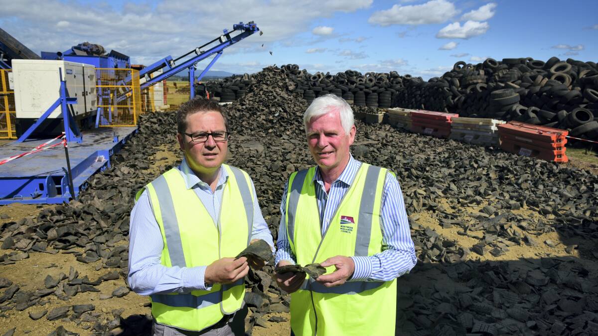 TyreCycle chief executive Jim Fairweather and Northern Midlands mayor David Downie  with a tyre chip after the tyres have gone through the shredder. Picture: PAUL SCAMBLER