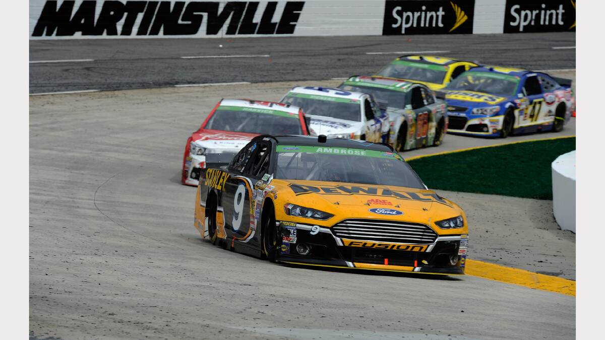Marcos Ambrose, driver of the #9 DeWalt Ford, leads a pack of cars during the NASCAR Sprint Cup Series STP 500 at Martinsville Speedway in Martinsville, Virginia. Photo: Getty Images