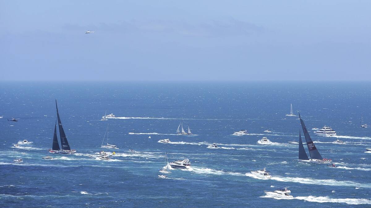 Comanche leads Wild Oats XI out of the Sydney Heads towards Hobart during the 2014 Sydney To Hobart on December 26, 2014 in Sydney, Australia. (Photo by Brett Hemmings/Getty Images)