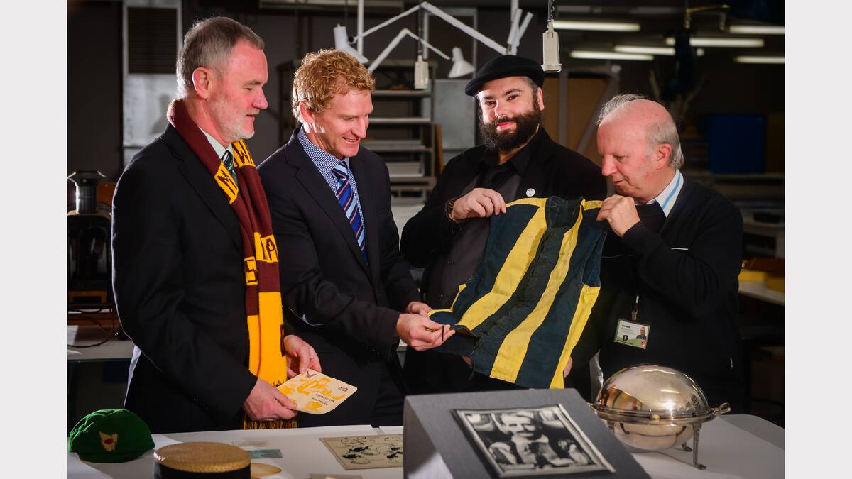 Launceston Mayor Albert van Zetten, Hawks Tasmanian Operations Manager Shayne Stevenson, QVMAG Curator of Contemporary Art Damien Quilliam, QVMAG Community History Research Officer Ross Smith with historical football related items at QVMAG. Photo by Phil Biggs