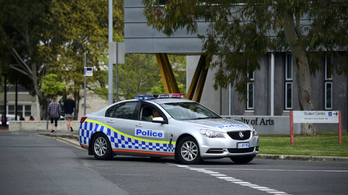 A police vehicle outside the University of Tasmania’s Launceston campus after security was beefed up following an online threat. Picture: PAUL SCAMBLER