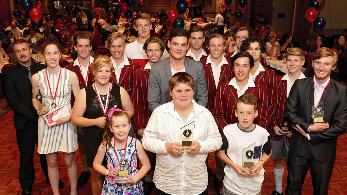 Former AFL footballer Nathan Grima (centre) is surrounded by winners at the The Examiner IGA Junior Sports Awards ceremony. Picture: PHILLIP BIGGS