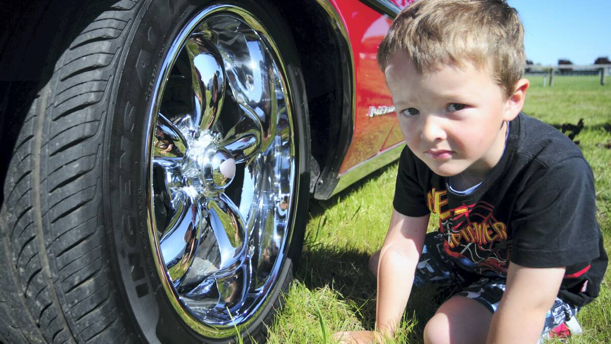 Nathaniel Riley-Coleman, 4, of Perth, loved the chromed wheels on the big American cars at Sunday’s Rock & Rodz event, at Longford. Picture: PETER SANDERS