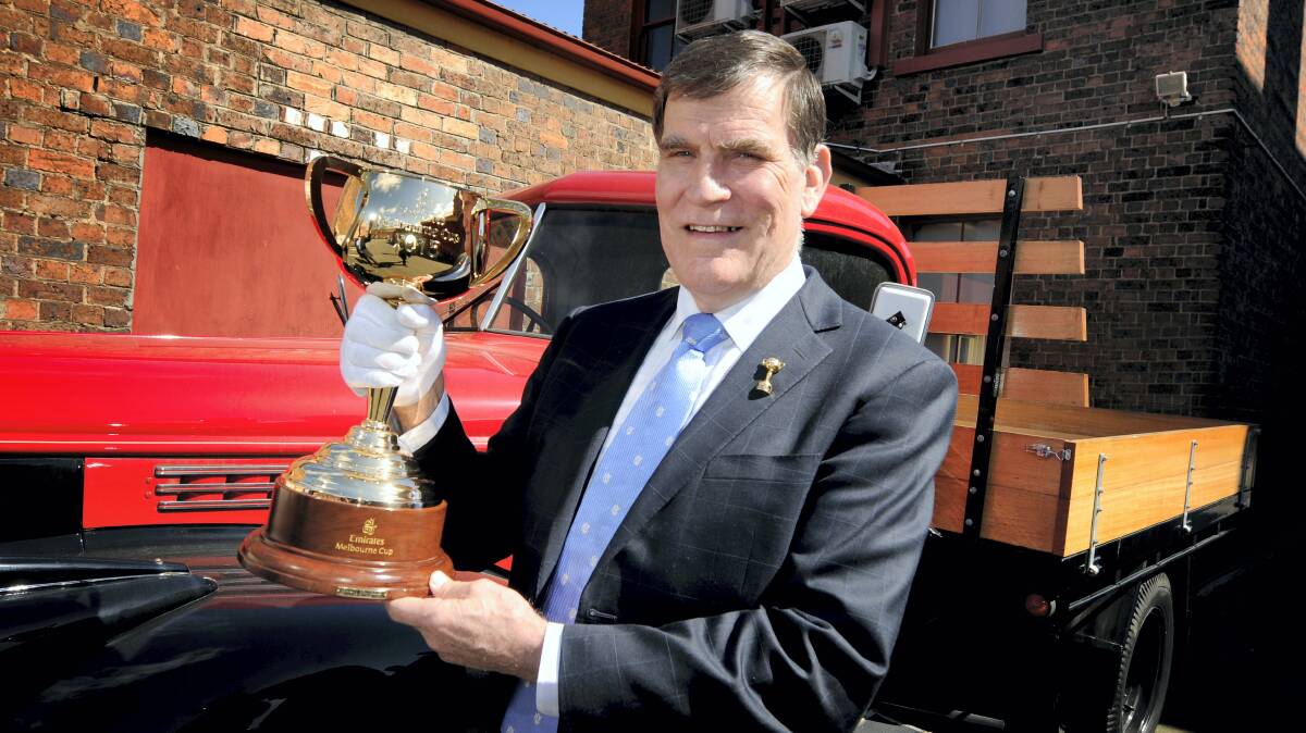 Former Victorian chief steward and Melbourne Cup ambassador Des Gleeson with the Melbourne Cup . Picture: GEOFF ROBSON