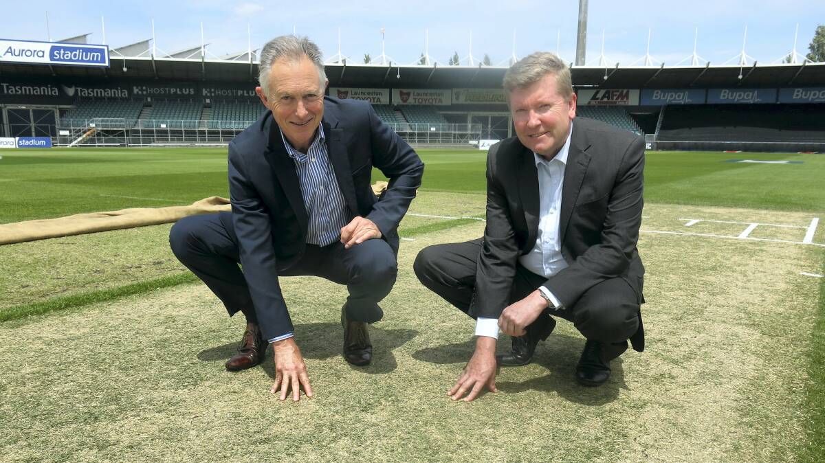 Cricket Tasmania chief executive David Johnston and chairman Andrew Gaggin check out the Aurora Stadium drop-in wicket on Wednesday. Picture: ALEX FAIR 