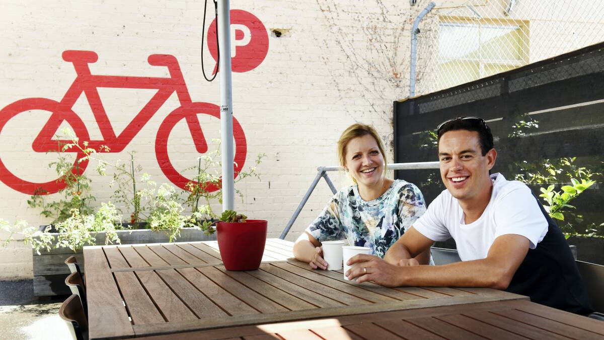 Richie Porte  takes a break  from his training and relaxes with a coffee  with his wife Gemma in Launceston this week. Pictures: SCOTT GELSTON