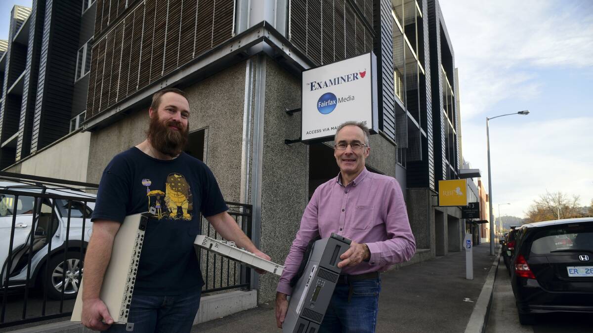 The Examiner’s IT support Ben Gibb and IT manager Michael Roberts move computer equipment into the company’s new offices in Cimitiere Street on Sunday. Picture: PAUL SCAMBLER