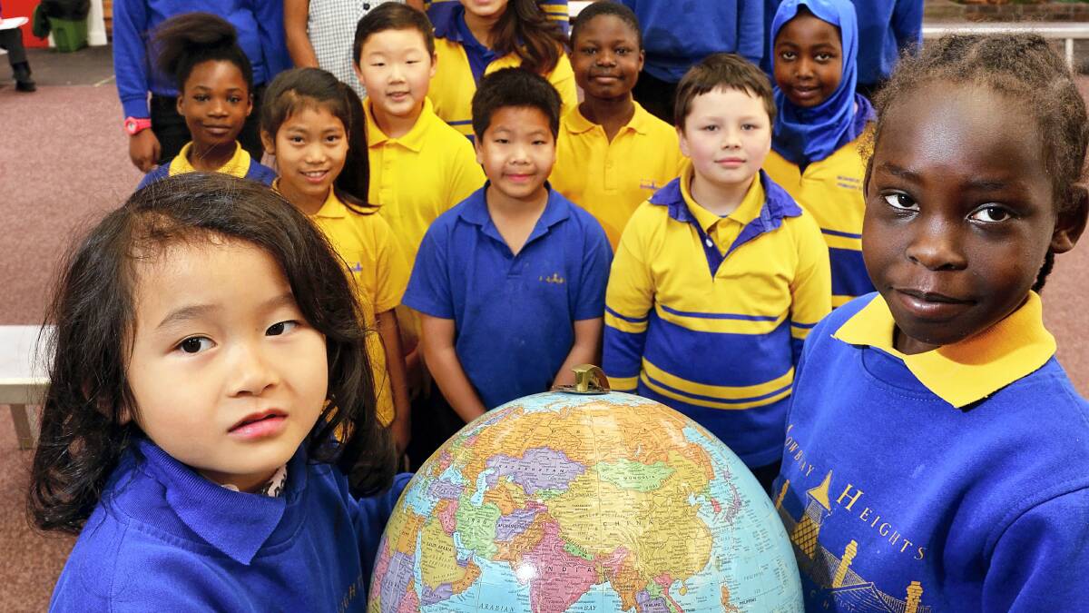 Mowbray Primary School pupils Ha Binh Nguyen, from Vietnam, and Nafahat Abdelrasoul, from Sudan, with fellow pupils from around the world. Picture: PHILLIP BIGGS