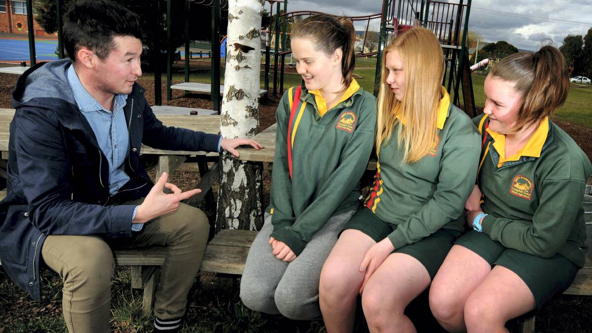 University student Toby Lutwyche talks to Campbell Town students Georgie Nicolson, 13, Isabelle Double, 12, and Holly Burn, 12. Picture: GEOFF ROBSON