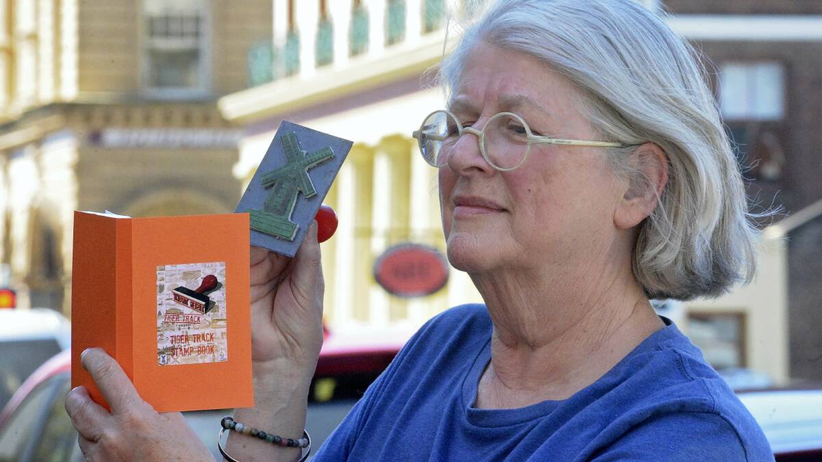 Kaye Green, of Austins Ferry, with her Tiger Track stamp book – an idea that  she developed from her time in Japan. Picture:  PHILLIP BIGGS
