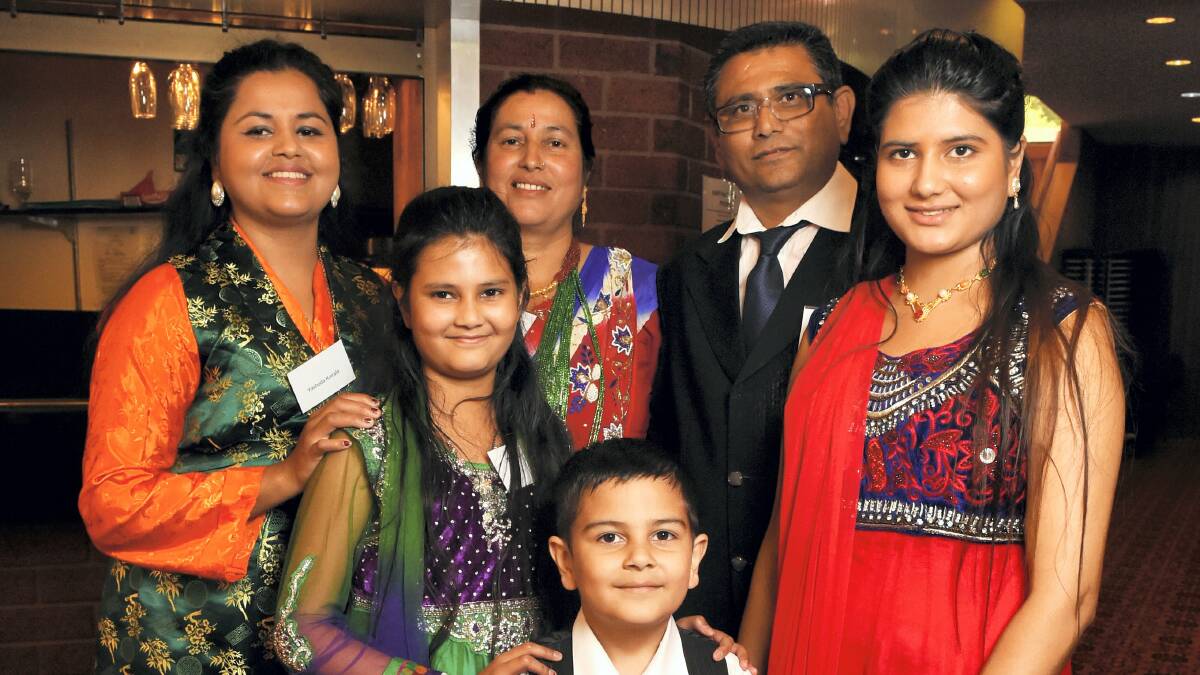 Happy to be Australian citizens, the Koirala family, of Mowbray, from left, Yashada, Muna, Surya and Kesabi.  Rear: Khina Maya and Rup Narayan.  Picture: MARK JESSER