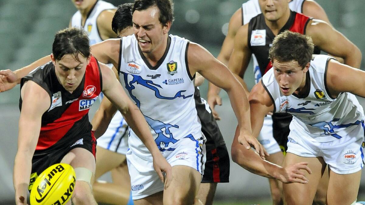 Western Storm players Beau Thorp and Matt Hanson put pressure on their West Adelaide opponents in Tuesday night's Foxtel Cup match at Adelaide Oval.   Picture: MATT PFEIL