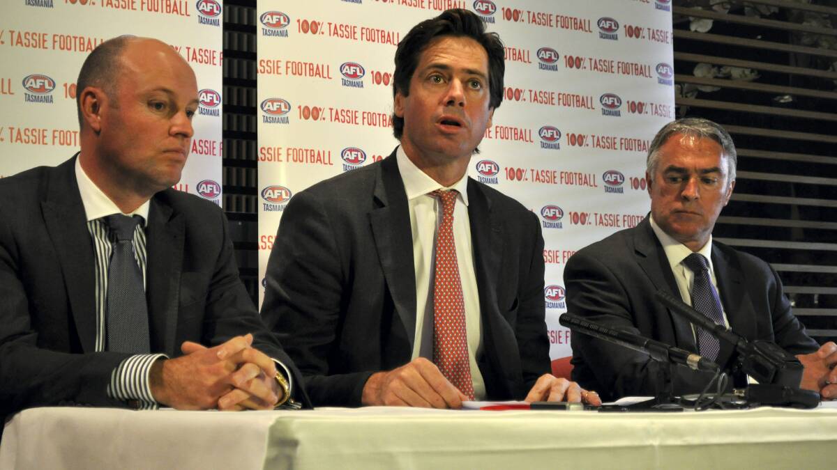 AFL deputy chief executive Gillon McLachlan  in Hobart yesterday flanked by AFL Tasmania outgoing chairman Dominic Baker and AFL Tasmania chief executive Scott Wade.