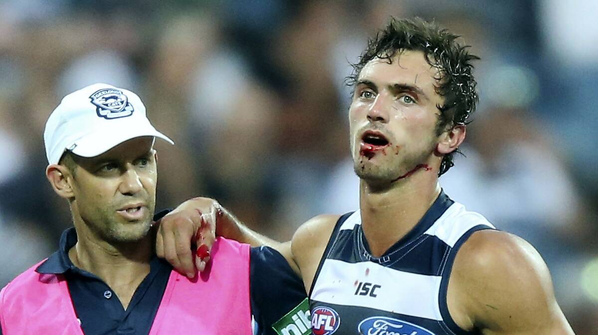Geelong player George Burbury is helped from the ground after breaking his jaw in a NAB Challenge match in February. The former Hobart forward is expected to return in the next fortnight.  Picture: GETTY IMAGES