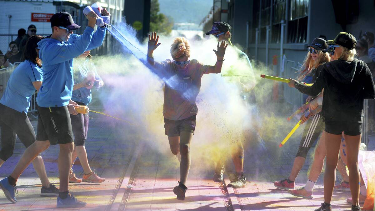 James Turner, 12,  of Launceston, runs the paint gauntlet at the Colour Me Active fun run yesterday. Picture: GEOFF ROBSON