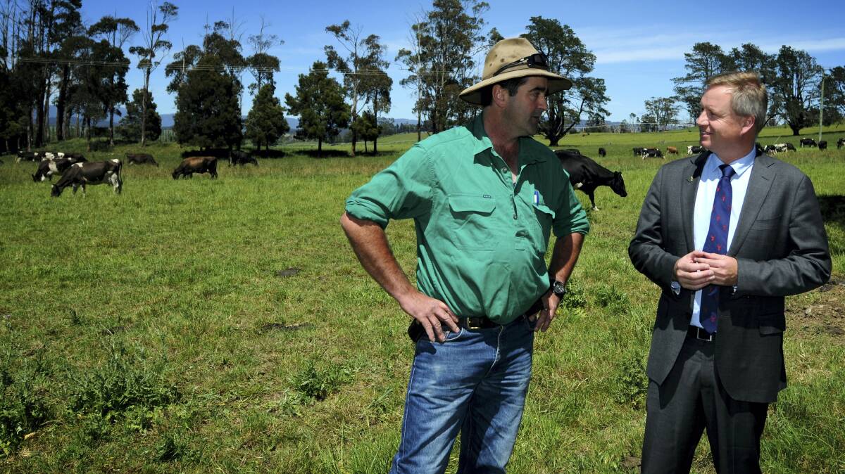 Primary Industries and Water Minister Jeremy Rockliff touts Australia’s free trade agreement with China along farmer and business owner Paul Bennett at Ashgrove Cheese yesterday. Picture: GEOFF ROBSON