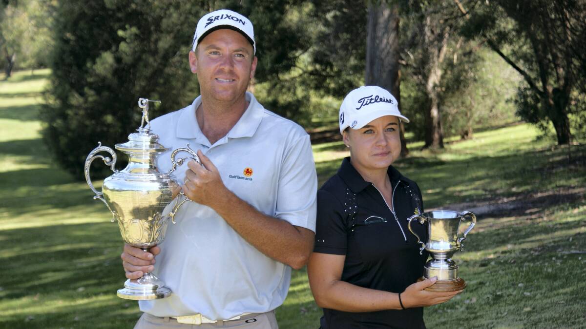 State amateur golf champions  Mark Schulze and women’s winner Hayley Bettencourt, of WA, show off their trophies after yesterday’s wins.