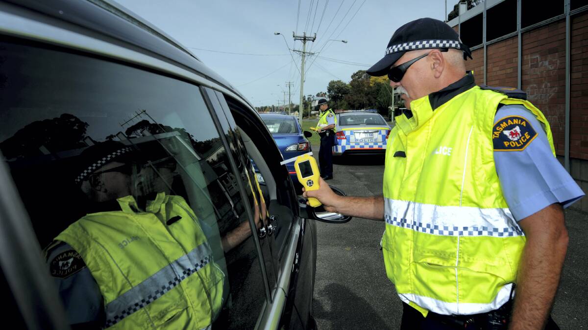 Constable Steve Greenwood, of  Northern Roads and Public Order Safety, gives a driver a breathaliser test. Police will be out in force over the Easter period. Picture: GEOFF ROBSON