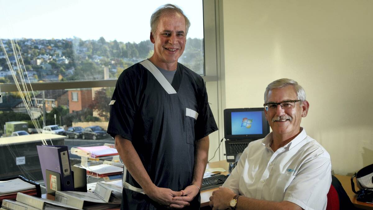 Cardiologist  Brian Herman and  business owner Mark Brown discuss Mr Brown's heart attack and recovery at the Launceston General Hospital yesterday. Picture: GEOFF ROBSON