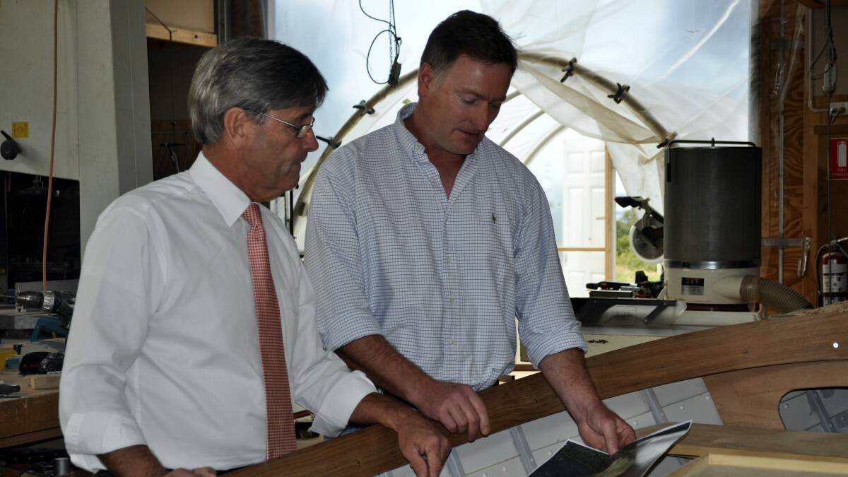 Resources Minister Paul Harriss and boatbuilder Andrew Denman discuss specialty timber logging.