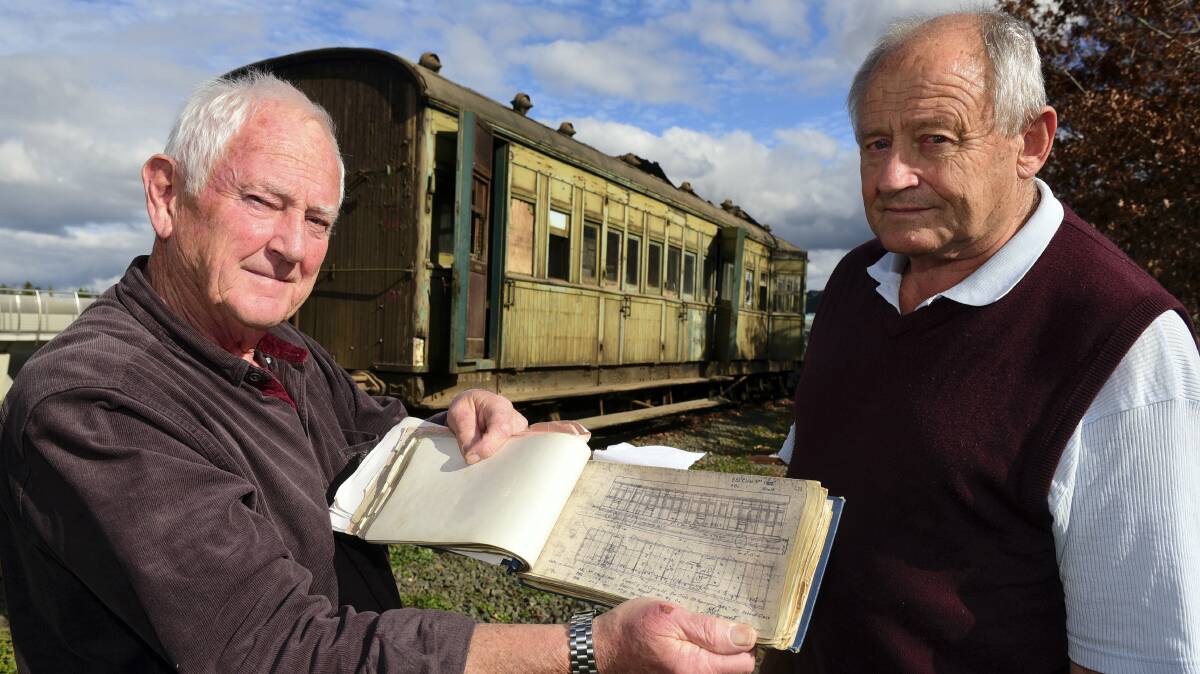 Billy Reynolds and Paul Fletcher, of the Don River Railway, at Inveresk with the 1922 ABL16 passenger carriage that will be restored. Picture: PAUL SCAMBLER