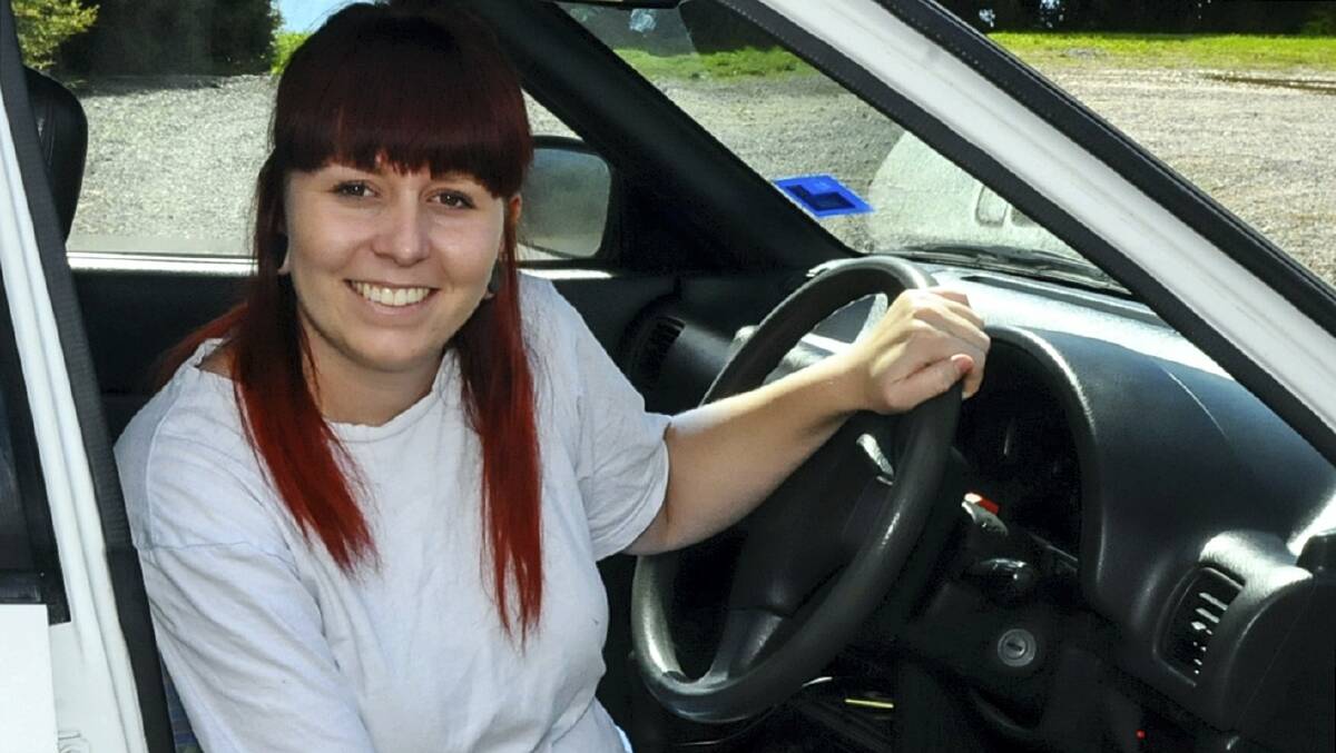 Amber McKenzie behind the wheel of her new U-Turn car ... her car called Kermit was stolen twice at Beauty Point. Picture: NEIL RICHARDSON