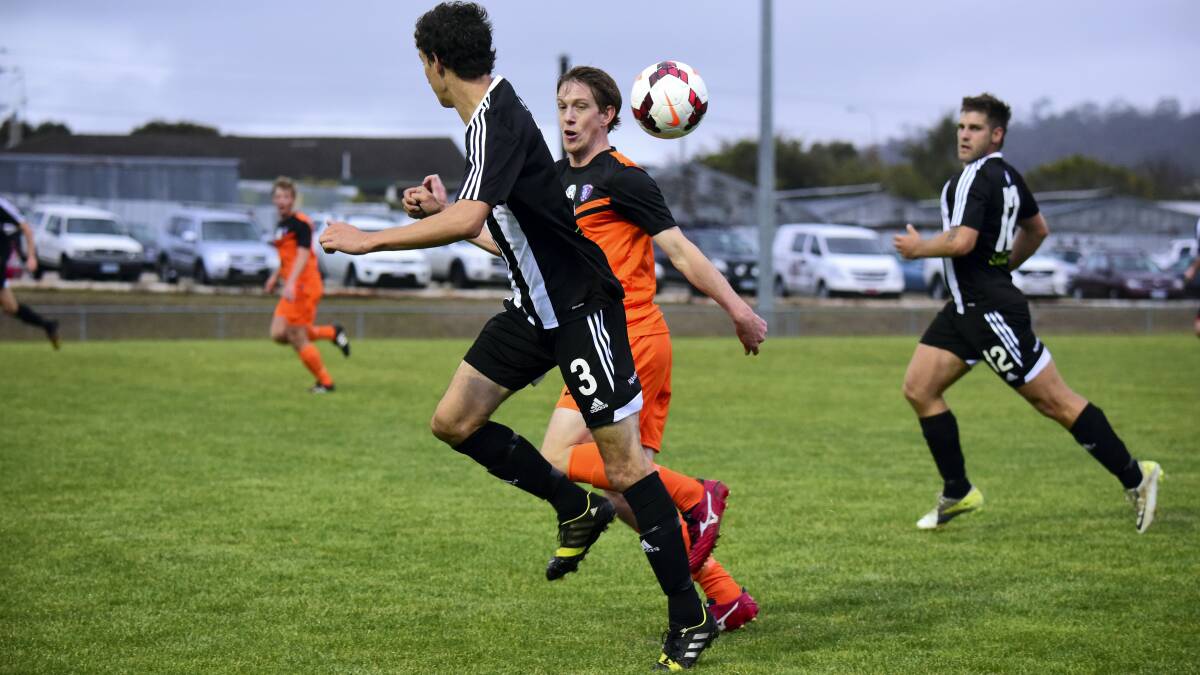 Launceston City’s Gregory Duffy and South Hobart’s Christopher Hunt during their match at Mitsubishi Park yesterday. Picture: PAUL SCAMBLER