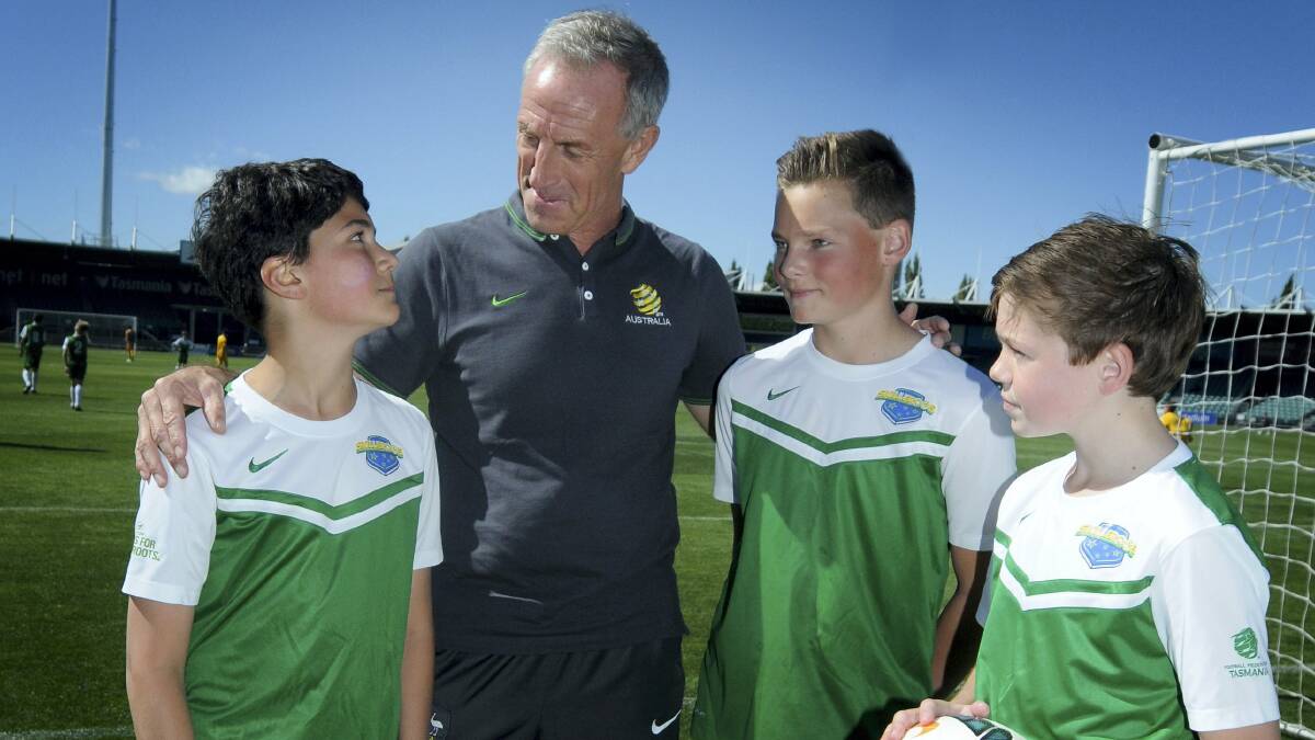 Alex Tye 12, of Hobart, the technical director of Football Australia, Eric Abrams, and Ethan Craw, 12,  and Ethan Melville, 13, both of Hobart.   Pictures: GEOFF ROBSON