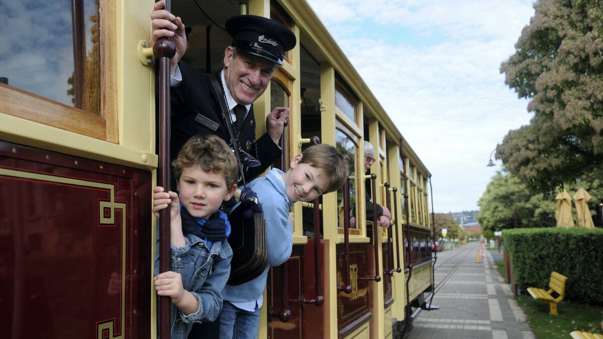 Tram conductor Michael Leslie with brothers Nixon, 4, and Baxter Adams, 7, of Perth. Picture: PAUL SCAMBLER