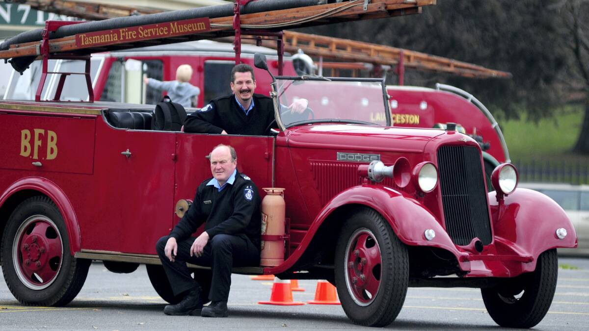 Tasmania Fire Service district officer John Hazzlewood, in front, and Longford Fire Brigade volunteer Damian Saunders with a 1937 Dodge fire truck.