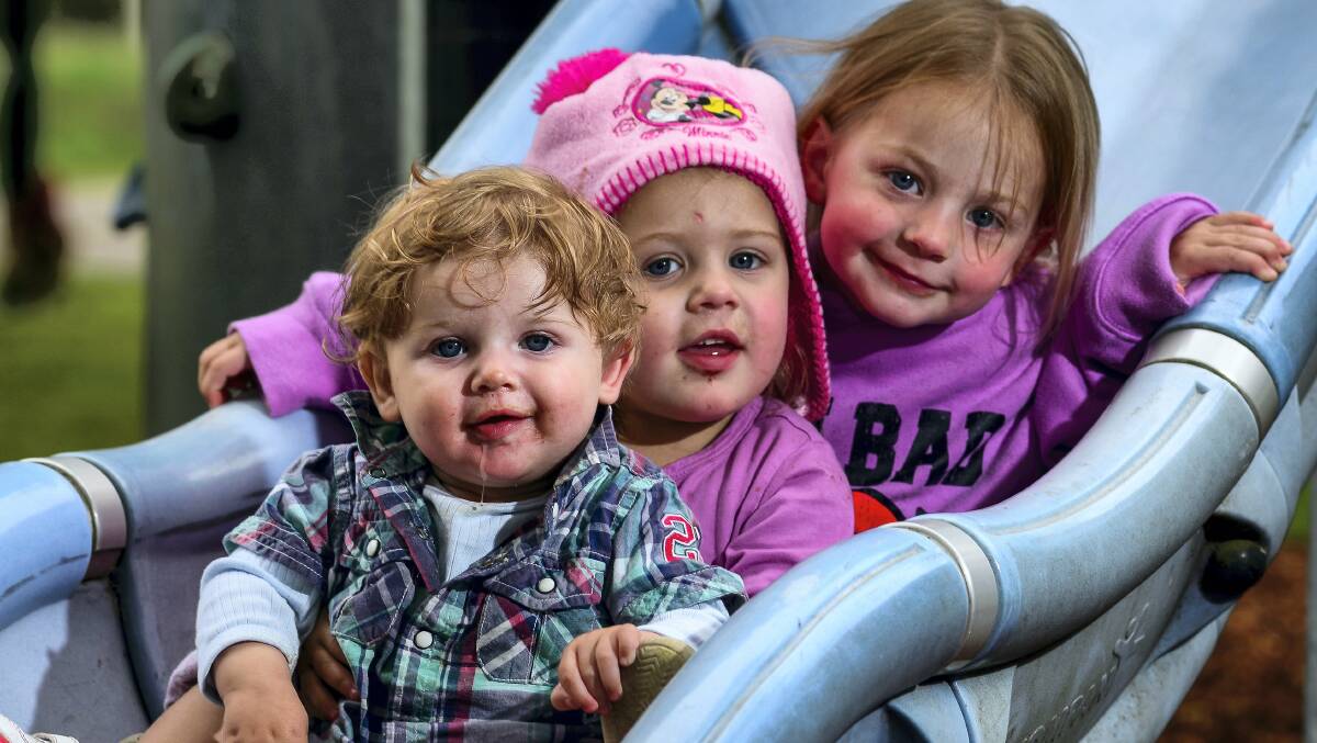 Jessiejames Leech, 9 months, with sisters Alexisrose, 3, and Annabella, 2, of East Launceston, playing in the park on a cool spring day at St Leonards. Picture: PHILLIP BIGGS