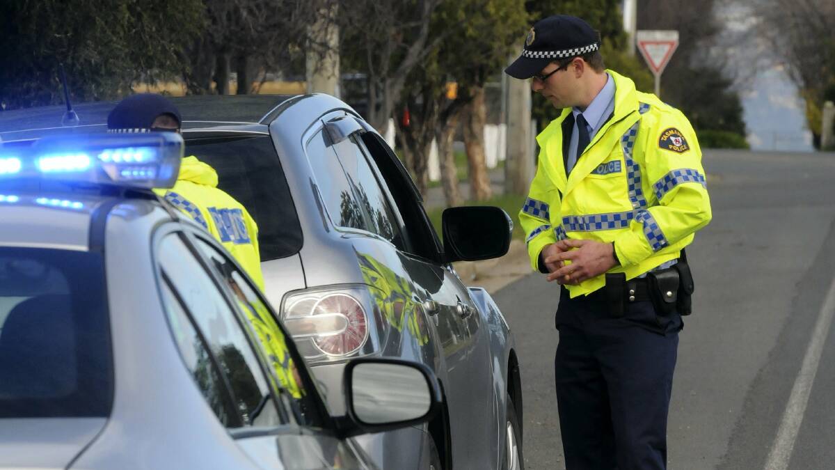 Northern road safety taskforce Constable Christian Schriever speaks to a driver in Launceston yesterday. Picture: PAUL SCAMBLER
