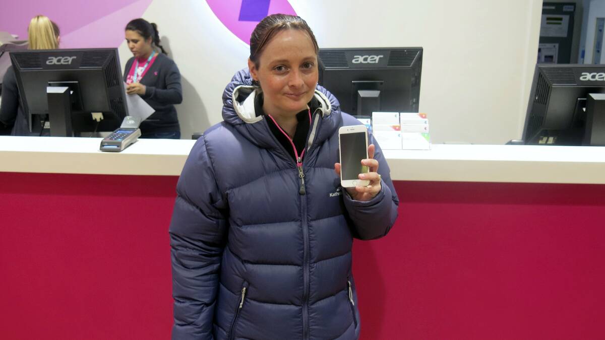 Maree Johnston, of Newnham, with her new iPhone 6, the first bought at Launceston’s Telstra Shop. 