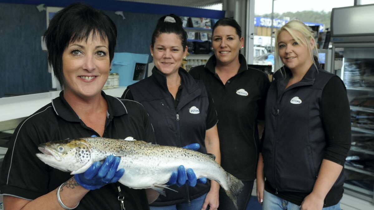 Petuna Seafoods manager Donna Clare (with an Atlantic salmon) and staff Terri-Anne Jones, Megan Ramskill and Kristie Harkins get ready for one of their busiest days of the year. Picture: PAUL SCAMBLER