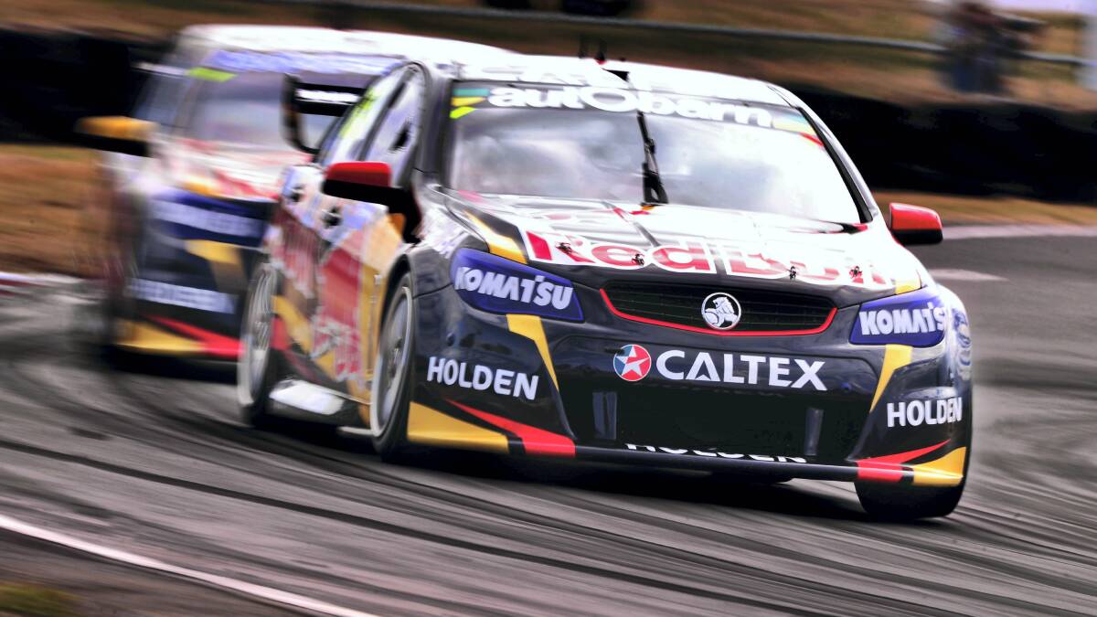 Red Bull Racing's Craig Lowndes leads Jamie Whincup during the first race of the weekend at Symmons Plains. Picture: SCOTT GELSTON