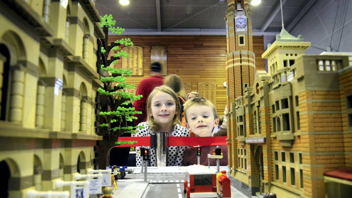 Mia, 8, and Hamish Goody, 4, of Launceston, stop to look at the details in Ken Draeger's recreation of Cameron Street which is part of his larger Civic Square exhibit. Picture: MARK JESSER