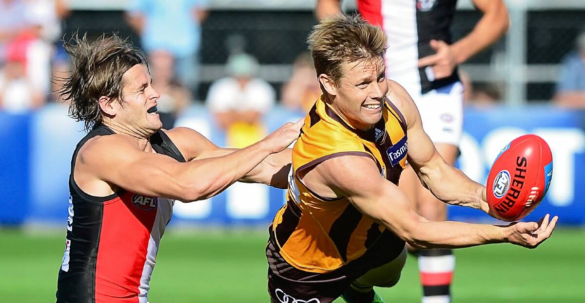 Hard-ball get: Action from last season's match between St Kilda and Hawthorn in Launceston. Maverick Weller will be back on Saturday but Sam Mitchell won't.