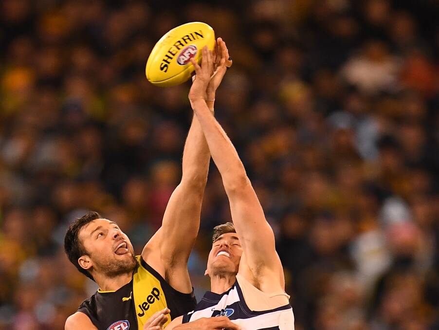 Reach for the skies: Toby Nankervis of the Tigers rucks with Geelong's Zac Smith during the second qualifying final at the MCG earlier this month. Picture: AAP.