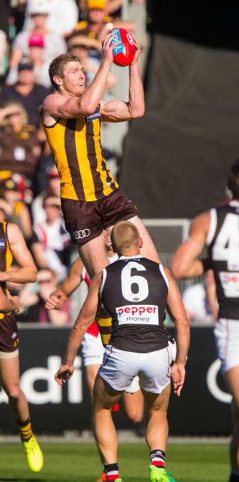 High flyer: Hawk Ben McEvoy takes a commanding mark before one of his two goals.
Pictures: Phillip Biggs