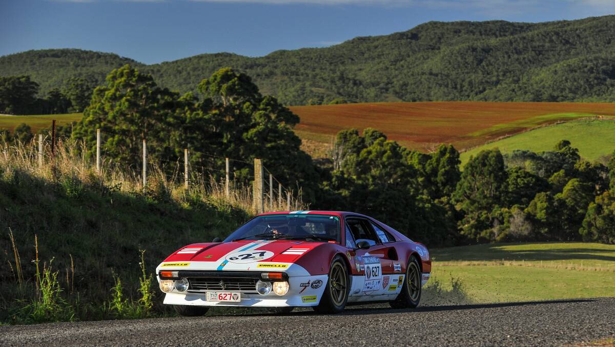 Colourful: David Gilliver, of Victoria, and Nigel Shellshear, of NSW, in their Ferrari 308 GTB heading through Montumana. Pictures: Angryman Photography