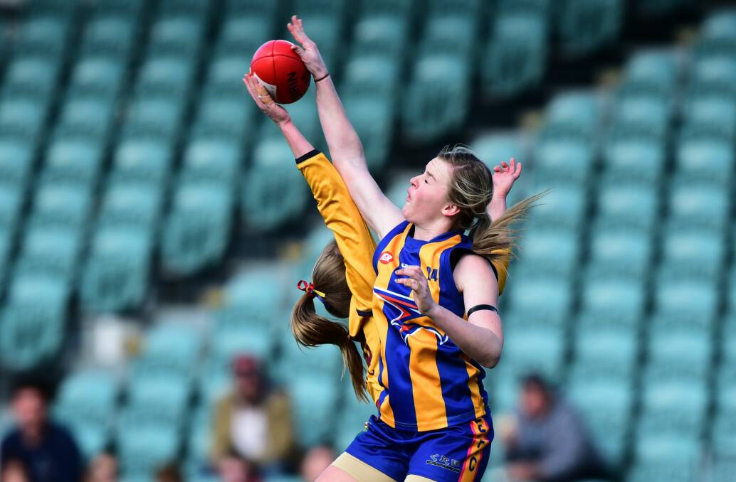 Evandale's Skye Brown reaches for the ball against East Launceston.