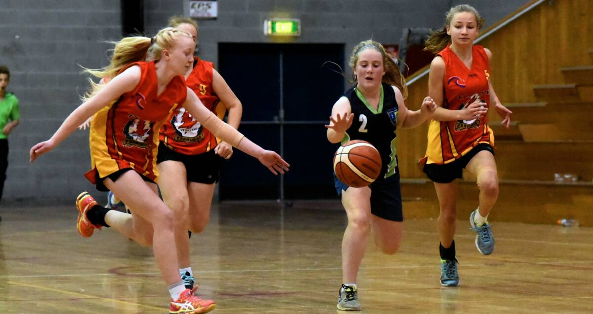 Dribble: Rebecca Barrett on the run for Westbury against St Helens at Launceston's Elphin Sports Centre. Pictures: Neil Richardson
