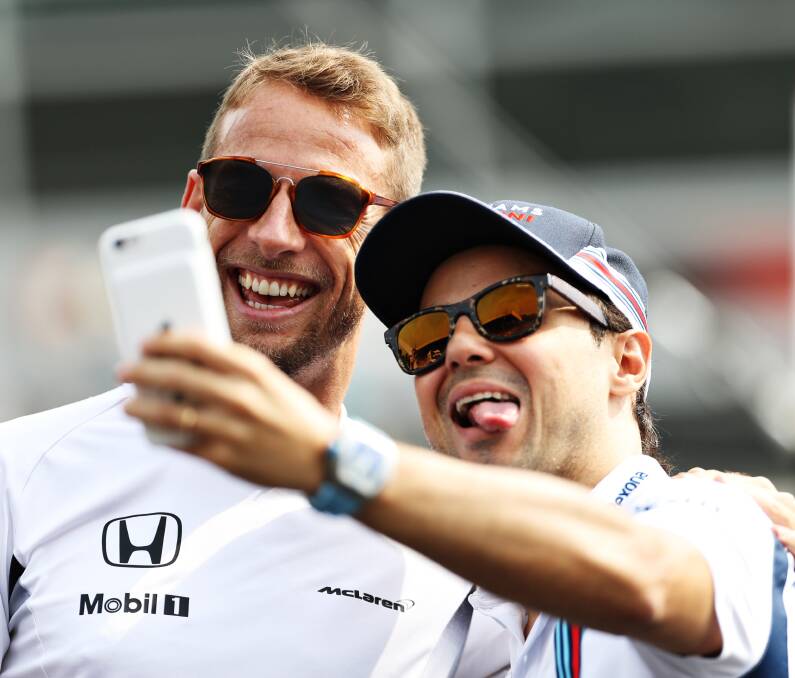 All smiles: Jenson Button of McLaren Honda and Felipe Massa of Williams take a selfie on the drivers parade during this year's Formula One Grand Prix of Italy in Monza. Picture: Getty Images