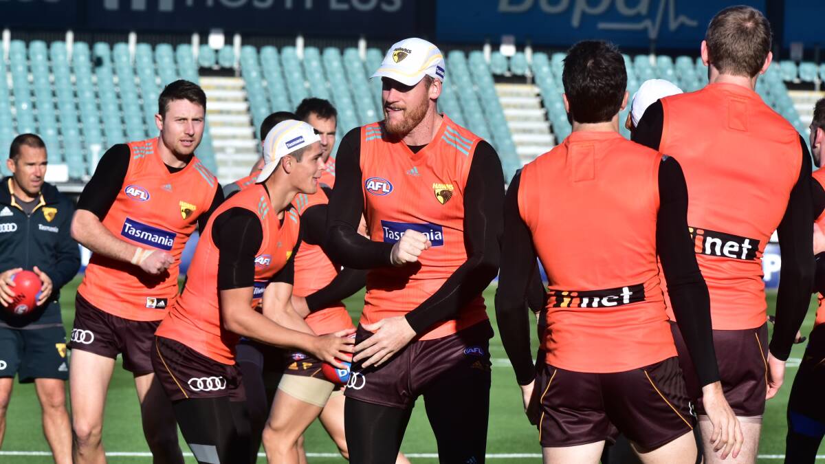 Red devils: Hawthorn captain Jarryd Roughead leads teammates through a training drill at UTas Stadium on Friday. Pictures: Neil Richardson
