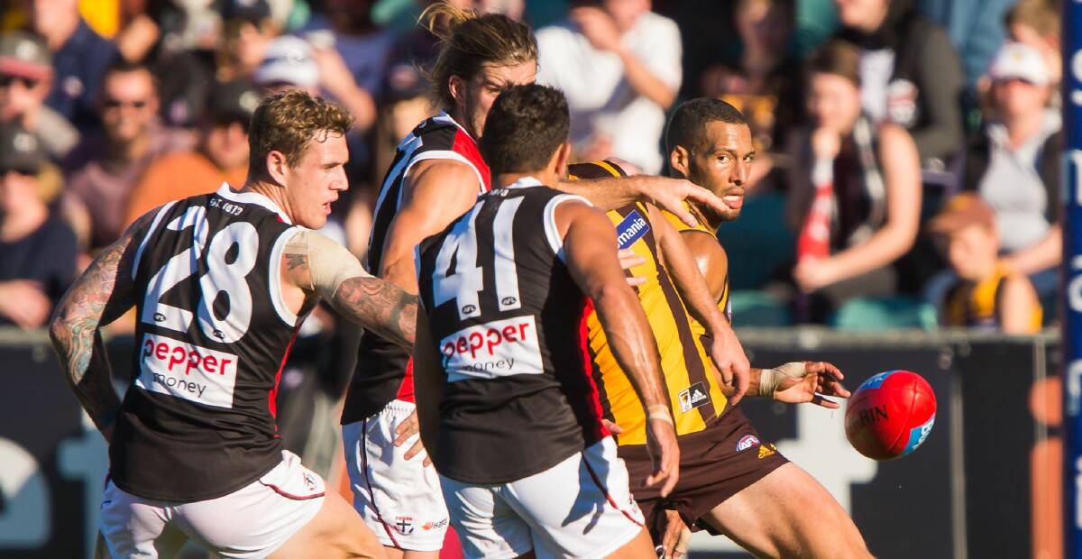 Pressure: Hawthorn's Josh Gibson gets gang tackled.