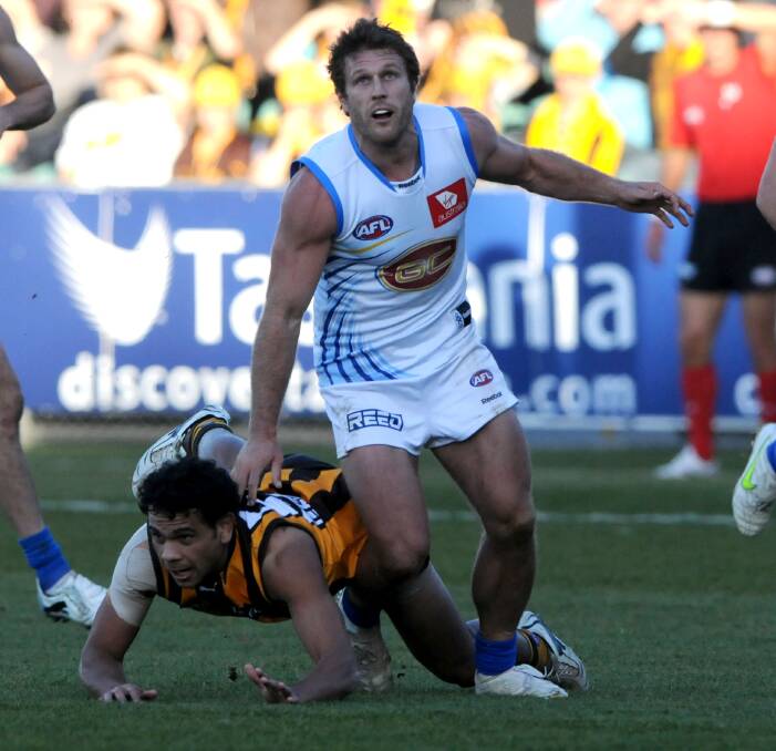 FLY IN: Former Hawthorn and Gold Coast player Campbell Brown up against Cyril Rioli at Aurora Stadium in 2011. He will line up for Bracknell on June 4.