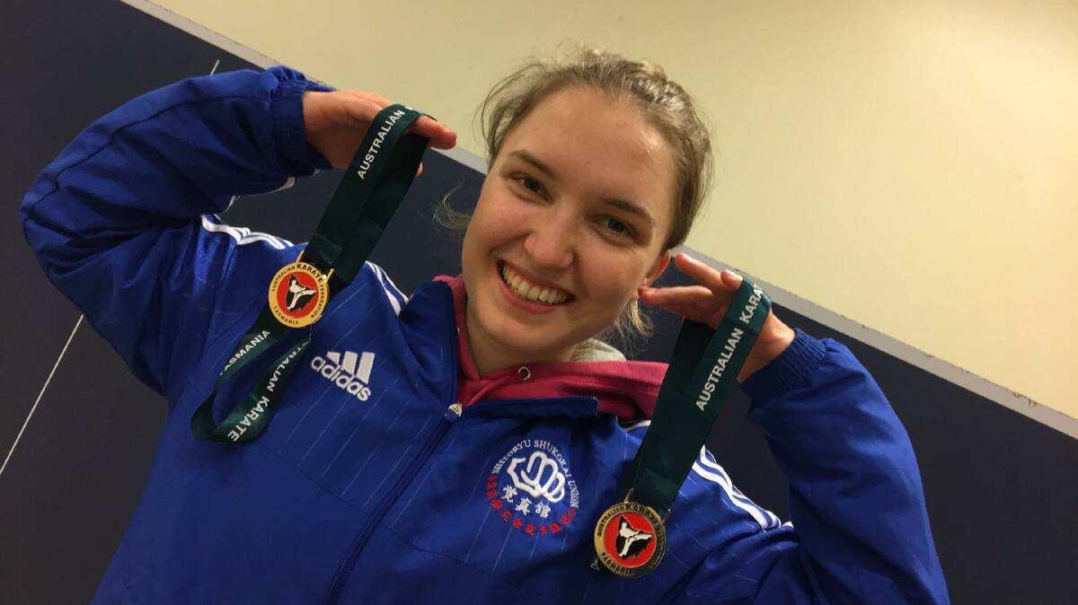 All smiles: Victorian Kelly Hoinville with her medals from the female senior open and mixed super kata divisions.