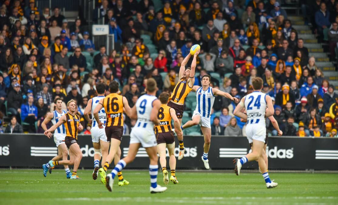 One direction: Hawthorn and North Melbourne clash in an AFL fixture in Launceston last August. Other sports have been taking an alternative view of Tasmanian involvement. Picture: Scott Gelston. 